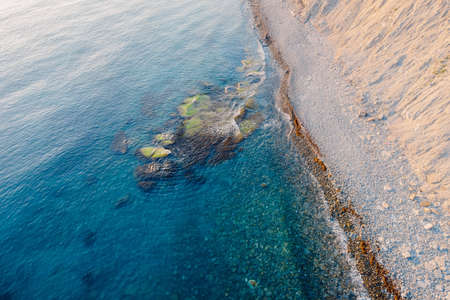 Aerial view of sea surface with stones and coastlineの写真素材