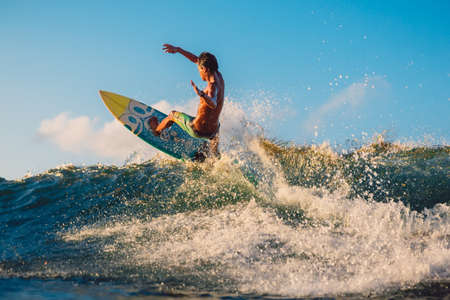 May 12, 2021. Lombok, Indonesia. Professional surfer does tricks on surfboard at ocean wave.