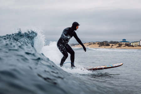 April 30, 2021. Anapa, Russia. Surfer in wetsuit wipeout on surfboard at ocean wave.のeditorial素材