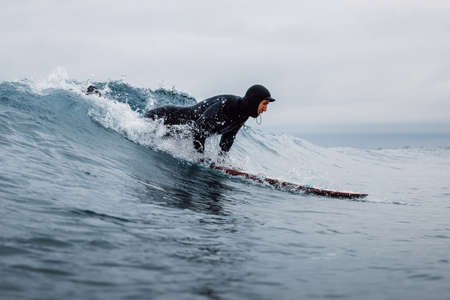 April 30, 2021. Anapa, Russia. Surfer in wetsuit wipeout on surfboard at ocean wave.のeditorial素材