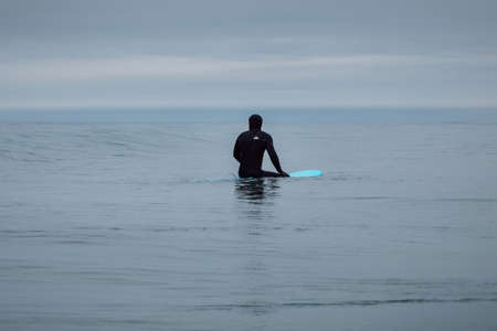 April 30, 2021. Anapa, Russia. Surfer in wetsuit wipeout on surfboard at ocean wave.