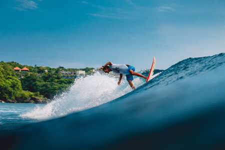 April 11, 2019. Bali, Indonesia. Indonesian surfer Alik Rudiarta training on surfboard at ocean wave.のeditorial素材