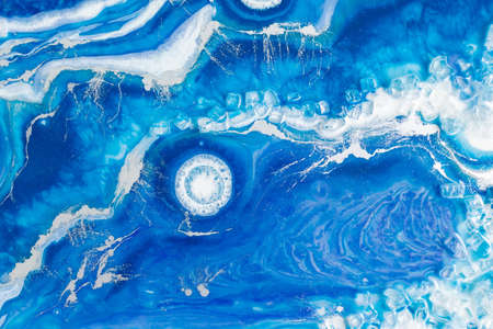 Epoxy resin art. Resin art with blue and white colors. Abstract composition for your design.