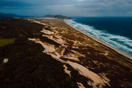 Scenic coastline with islands in blue ocean with waves in Brazil, Saquinho beach. Aerial viewの写真素材