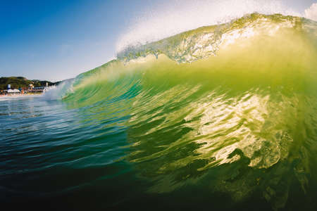 Perfect surfing wave in the ocean. Glassy barrels waves with morning lightの写真素材