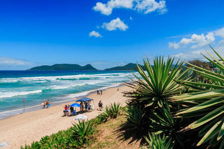 January 8, 2022. Florianopolis, Brazil. Holiday beach with people and blue ocean with waves in Brazil. Morro das Pedras beach in Florianopolisのeditorial素材