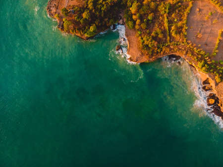 Tropical ocean with waves and surfer in Bali. Aerial view at Balangan beach.の写真素材