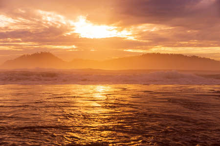 Sunrise with clouds and silhouette of Campeche island in Florianopolis, Brazilの写真素材