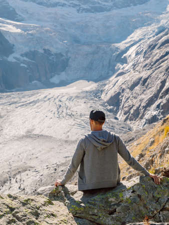 Motivation concept with hiker man in the mountains. Mountain with glacier and hiker touristの写真素材