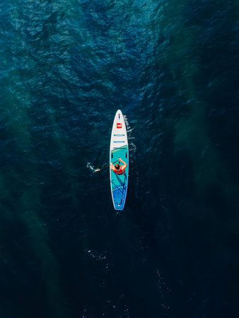 July 11, 2022. Dalaman, Turkey. Two woman on stand up paddle board in blue sea. Vacations on Red...