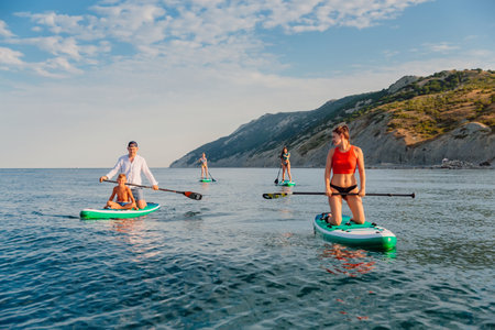 July 11, 2022. Dalaman, Turkey. Two woman on stand up paddle board in blue sea. Vacations on Red...