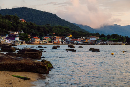 May 1, 2022. Florianopolis, Brazil. Colorful houses in Ribeirao da Ilha village and ocean coastline at sunsetの写真素材