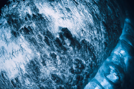 Ocean wave texture with foam, vortex underwater in transparent sea water.の写真素材