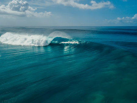 Perfect glassy wave with barrel in blue ocean. Aerial view