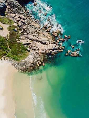 Rocky coastline with beach and ocean in Brazil. Aerial view of Praia da Galheta in Floripa. Top view