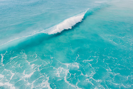 Blue ocean and surfing wave. Surfing dream in tropics. Aerial view