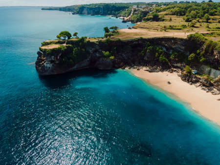 Aerial view of sandy beach with scenic rock and blue ocean in Baliの写真素材