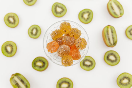 Sweet candied fruit jelly with kiwi fruits on white. Flat lay, top view.の写真素材