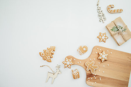 Homemade gingerbread cookies on wooden board with tree decoration. Christmas cookie, winter holidaysの写真素材