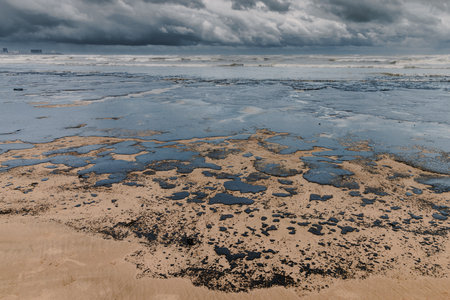 Oil in sea coastline after a tanker wreck. Oil fuel polluted beachの写真素材