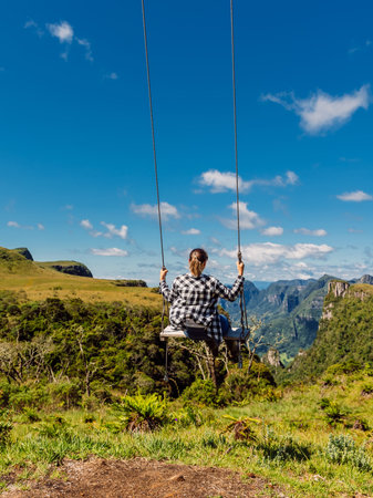 Woman on a swing in Canyon park in Santa Catarina, Brazil.の写真素材