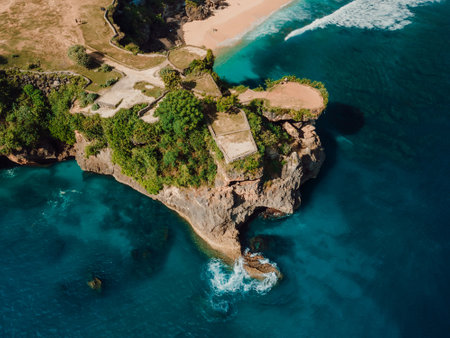 Aerial view of beach with scenic rock and ocean in Bali, Balangan beach.