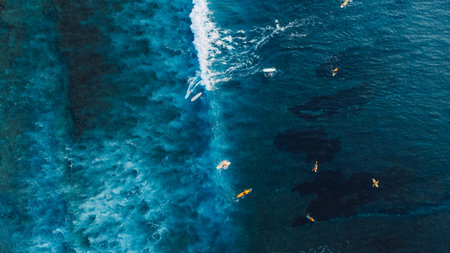Aerial view of a lot of surfers during surfing on ocean waves. Waves with surfers in oceanの写真素材