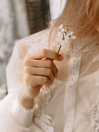 Woman holding a branch with blooming flowers. Spring beauty conceptの写真素材