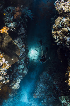 Woman freediver dives in underwater cave, extreme free divingの写真素材