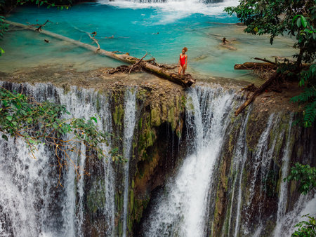 Attractive woman on cascade waterfall in Central Sulawesiの写真素材