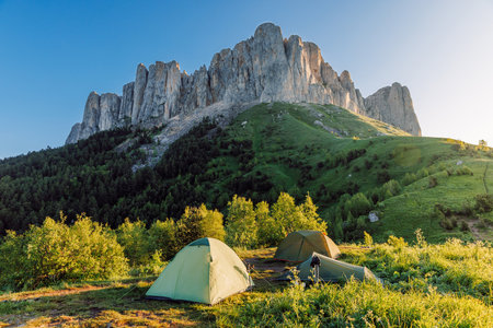 Scenic camping spot in the mountains with a tent at sunrise, Bolshoy Tkhach national parkの写真素材