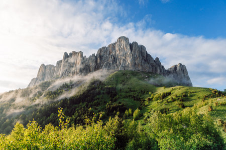 Natural park Bolshoy Tkhach mount with fog, sky and sunlight. Caucasus Mountains in Russiaの写真素材
