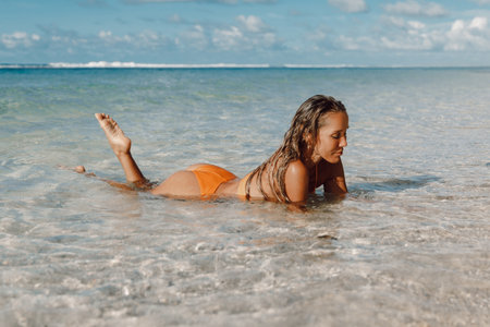 Attractive woman in bikini enjoy in water at tropical beach. Beautiful adult model at ocean coastの写真素材