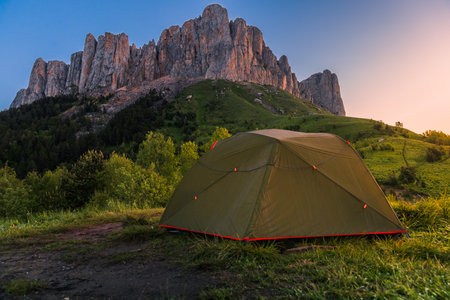 Scenic camping spot in the mountains with a tent at sunrise or sunset, Bolshoy Tkhach national parkの写真素材