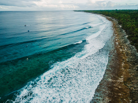 Drone view of ocean with waves and coastline on Fuvahmulah island in Maldives