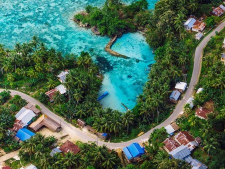 Sea coastline with blue lagoon and village with road in Indonesia. Aerial viewの写真素材
