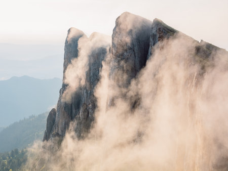 Bolshoy Tkhach mountain in Caucasus with clouds and pre sunset lightの写真素材