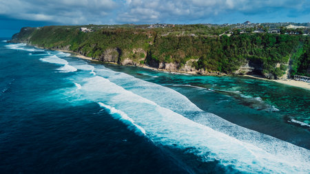 Tropical scenic coastline with cliffs and blue ocean with waves in Bali. Aerial viewの写真素材