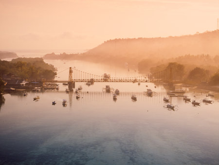 Aerial view of a bridge connecting two islands over ocean channel. Nusa Lembongan and Nusa Ceningan bridge with boats.の写真素材