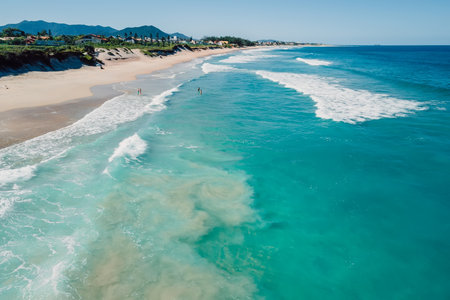 Sandy beach and blue ocean with waves on sunny day in Brazil. Drone viewの写真素材
