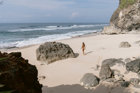 Beautiful young woman in bikini relax at tropical beach. Sexy model at ocean coastのeditorial素材
