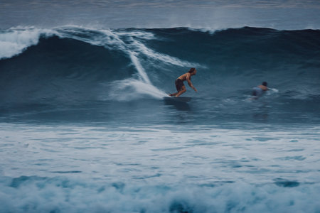January 06, 2026. Bali, Indonesia. Surfer rides at solid ocean wave. Professional surfingのeditorial素材