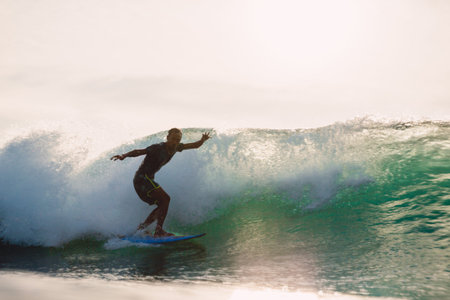 February 24, 2026. Bali, Indonesia. Surfer rides on a ocean wave. Professional surfing in ocean on...