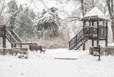 Children's playground during heavy snowfall.の写真素材