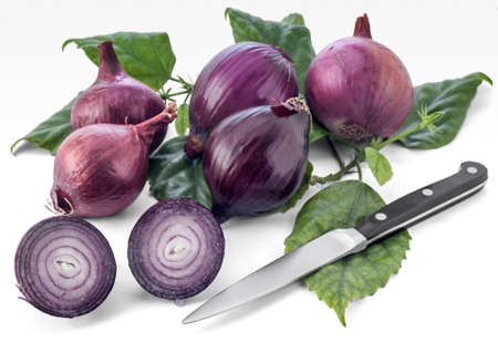 Group of red spanish onions and a kitchen knife isolated on white background.の写真素材