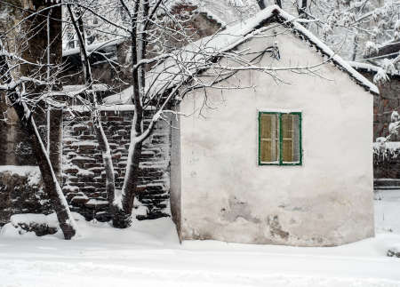 Tiny house, with only one window, on a snowy day. This photo was taken during the winter of 2009/10. The house that does not exist any more.のeditorial素材