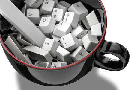 104 keyboard keys in cappuccino mug isolated on white background. Keyppuccino?の写真素材