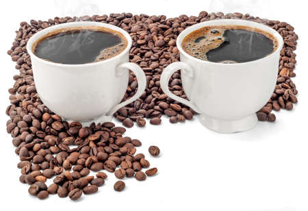 Two cups of coffee surrounded by coffee beans on white background. Extended Depth of Field and useful Copy Space in the lower right corner.の写真素材