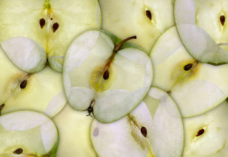 A semi transparent background of sliced apples Granny Smith with bright backlight.の写真素材