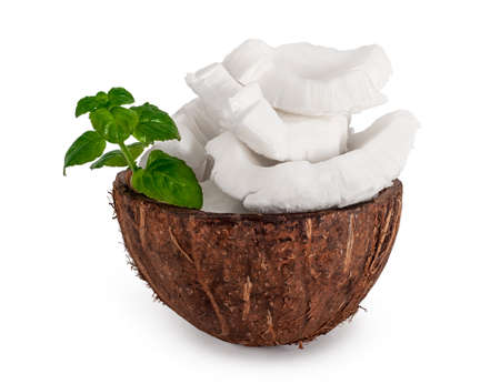 Coconut bowl with coconut pieces and mint leaf, isolated on white.の写真素材